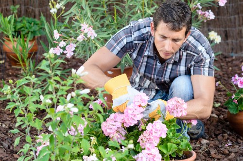 Worker measuring a pile of garden soil for cubic-yard estimate